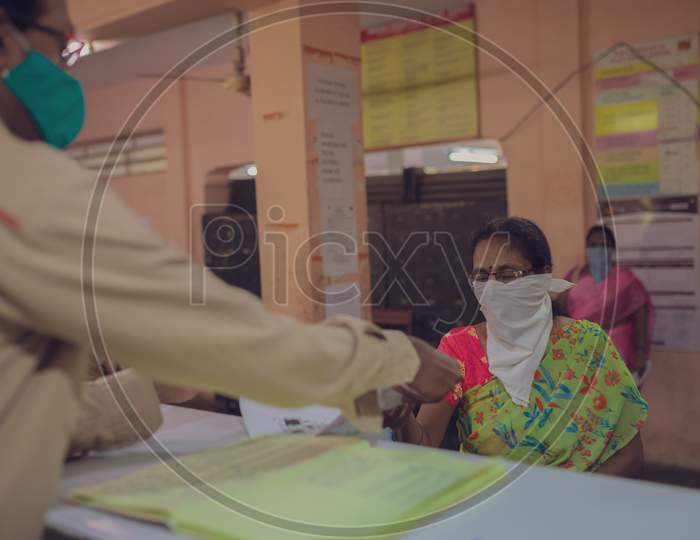 Beneficiary receiving money At post office in corona virus lockdown
