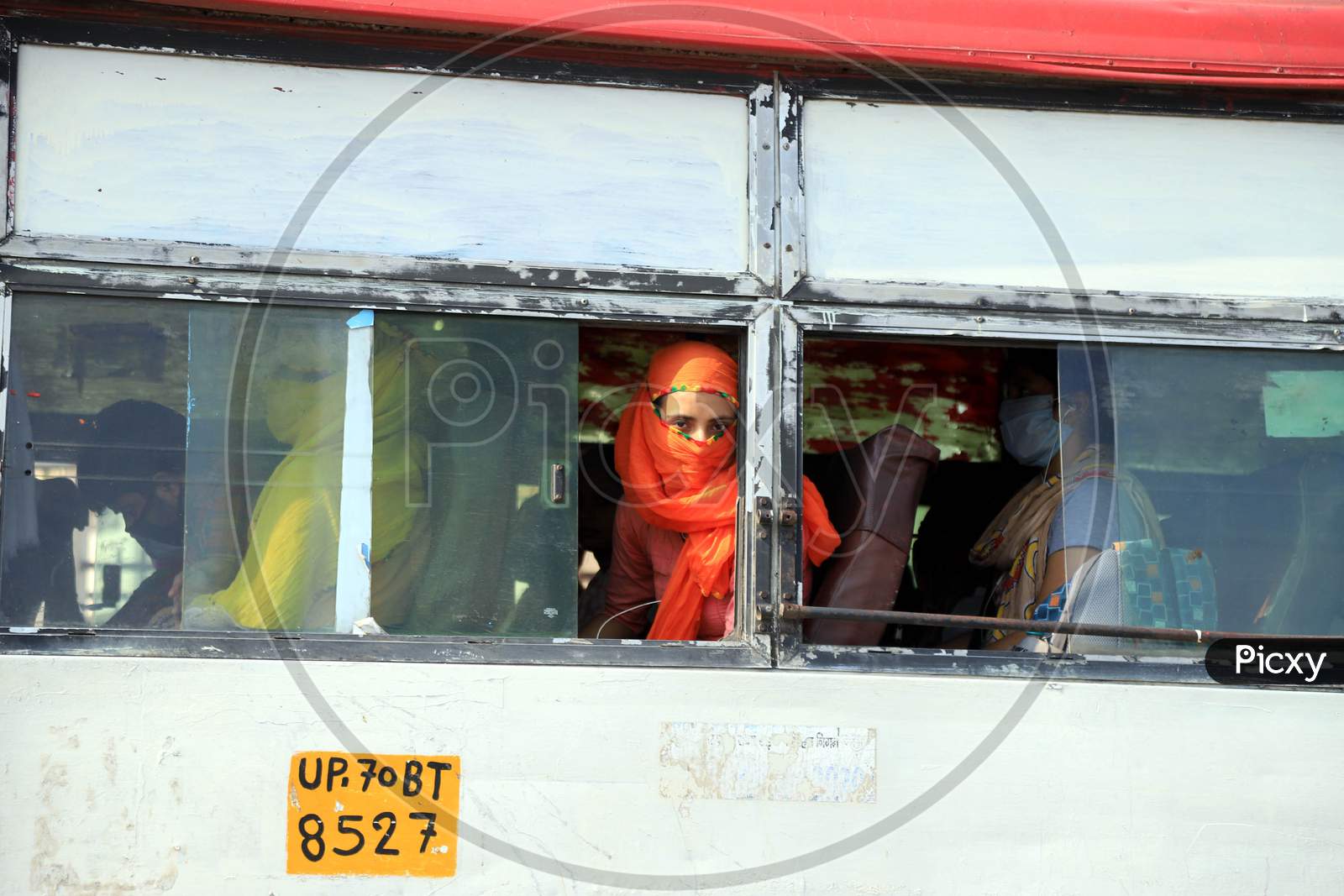 Students who had been stranded in Prayagraj for more than a month, due to the lockdown taken as a preventive measure to curb the spread of novel coronavirus, board a specially arranged bus to reach their respective hometown on April 29, 2020.
