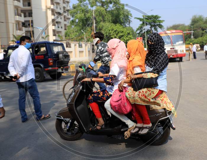 Girls tripling on a motorbike during government imposed nationwide lockdown as a preventive measure against the COVID-19 or Coronavirus in Prayagraj on April 29, 2020.