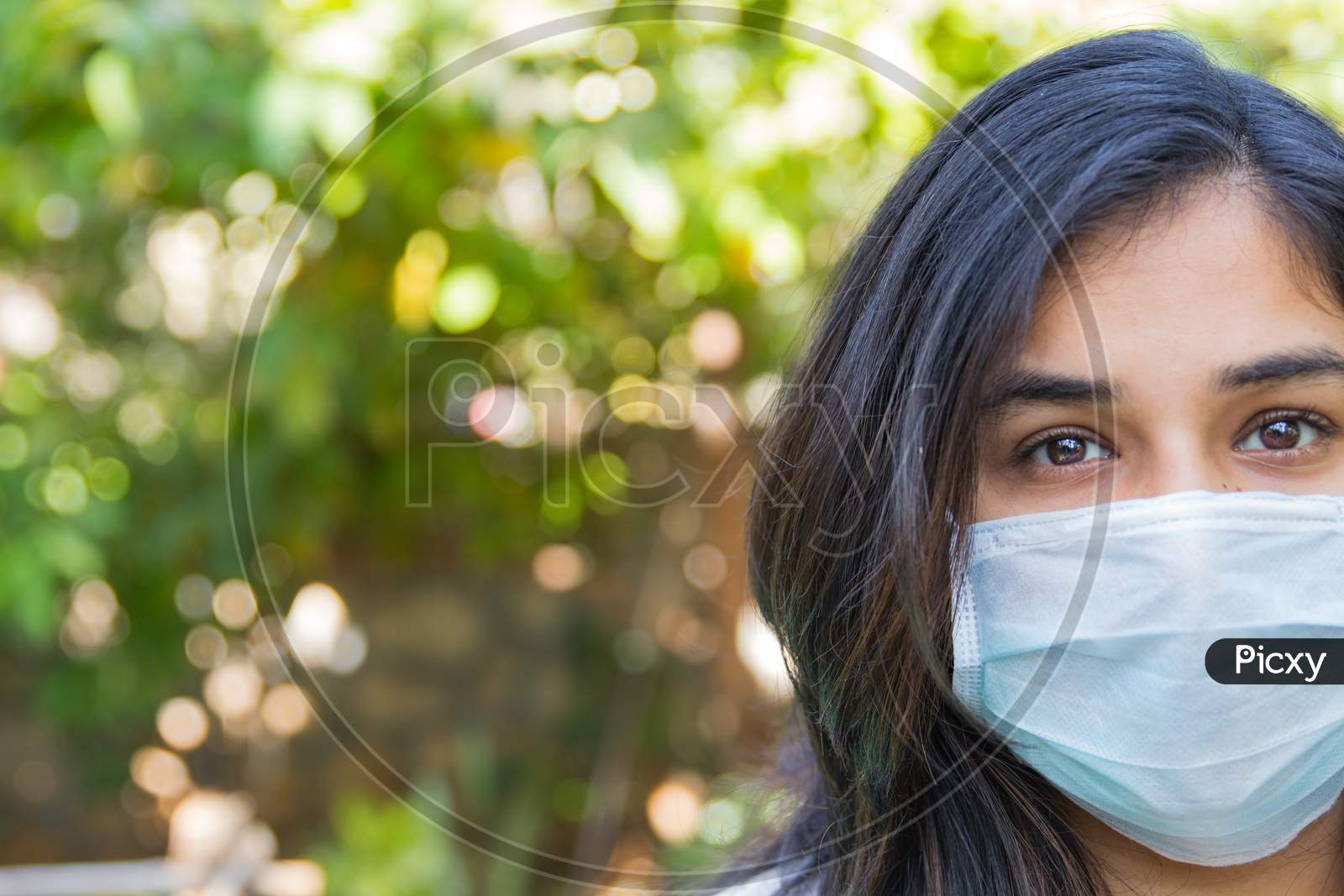 Half Face Portrait Of An Indian Girl Wearing A Face Mask During Covid 19 Pandemic As The Lock Down Continues In India Due To Increasing Spread Of Corona Virus Outbreak