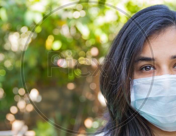 Half Face Portrait Of An Indian Girl Wearing A Face Mask During Covid 19 Pandemic As The Lock Down Continues In India Due To Increasing Spread Of Corona Virus Outbreak