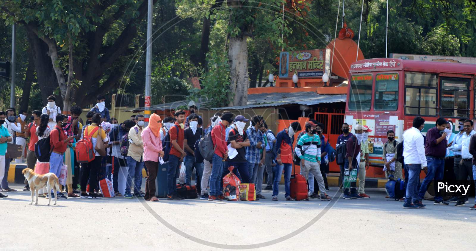 Students who had been stranded in Prayagraj for more than a month, due to the lockdown taken as a preventive measure to curb the spread of novel coronavirus, board a specially arranged bus to reach their respective hometown on April 29, 2020.