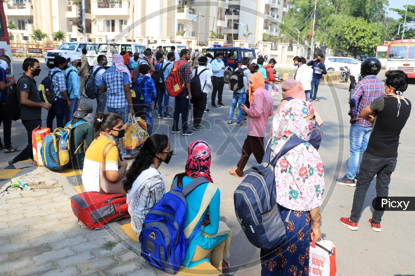 students who had been stranded in the city for more than a month due to lockdown imposed to prevent the spread of Coronavirus board a specially scheduled bus to their respective hometowns, in Prayagraj on April 29, 2020.