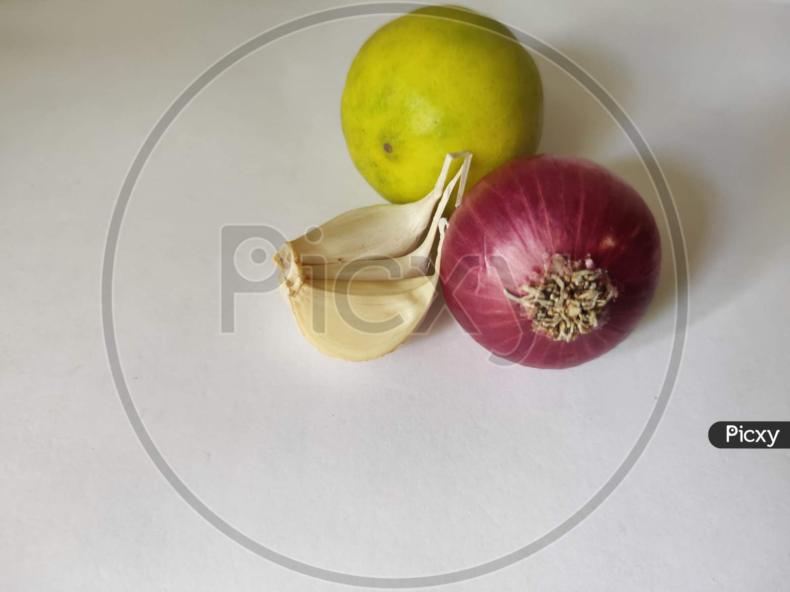 Onion garlic and lemon on white background. Lemon garlic and onion on plain background. Fresh vegetables close up.