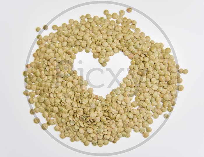 The Heart Shape Assembled With Grains Of Lentil On The White Background. Selective Focus. Healthy Eating Concept.