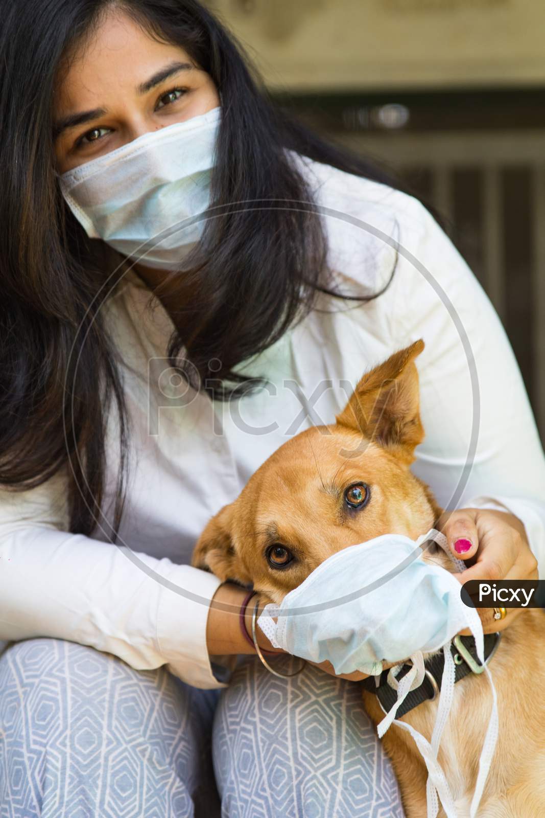 An Indian Health Worker And Her Pet Dog Wearing A Mask During Corona Virus Pandemic and Spreading The Awareness