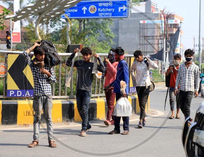 Migratory laborers walk on the road during government imposed nationwide lockdown as a preventive measure against the COVID-19 coronavirus in Prayagraj, April 29, 2020.