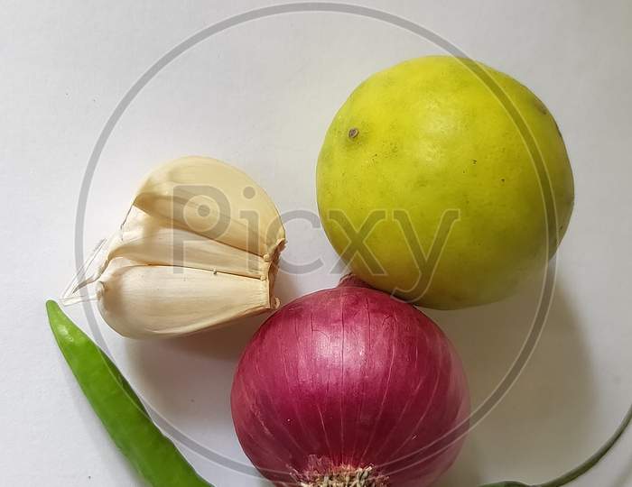 Onion garlic and lemon on white background. Lemon garlic and onion on plain background. Fresh vegetables close up.