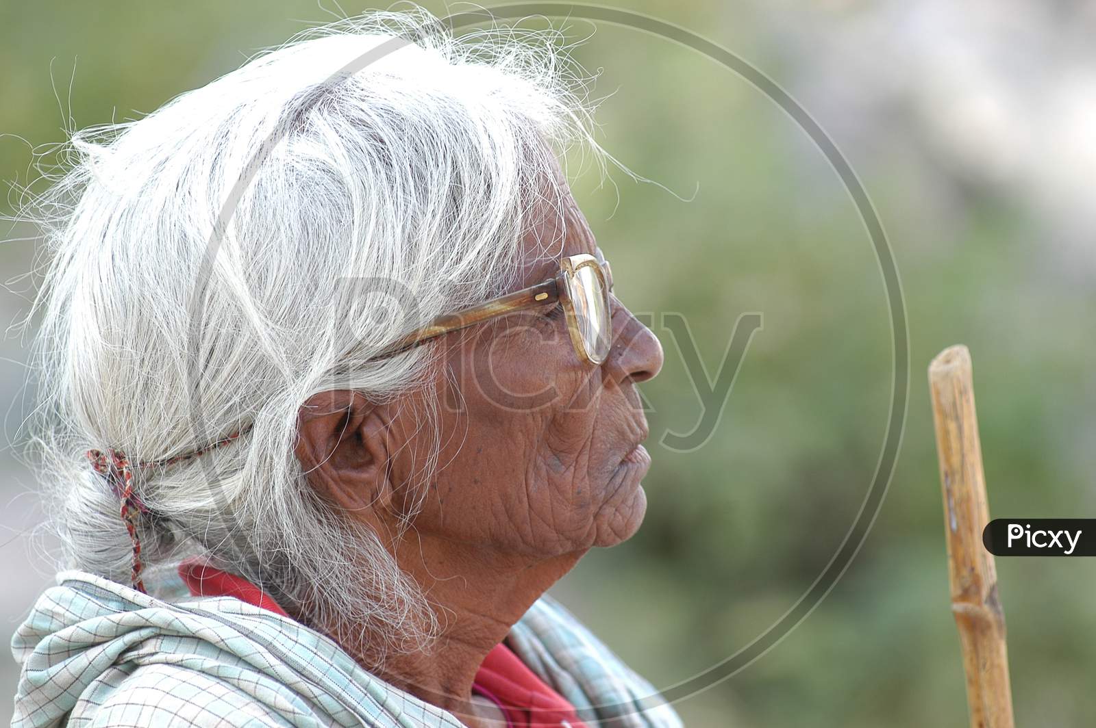 Indian Elderly Woman Standing at a Rural Village House