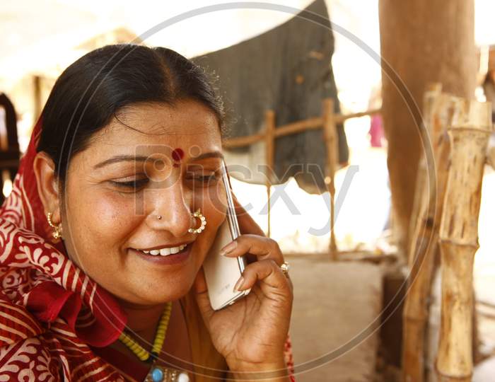 Rural Village Woman  Speaking In Mobile Phone