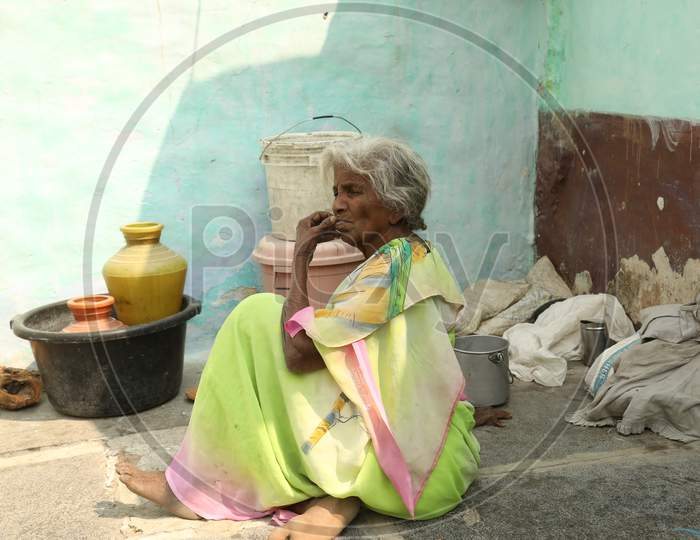 An Elderly Woman Sitting In an  Rural Village House