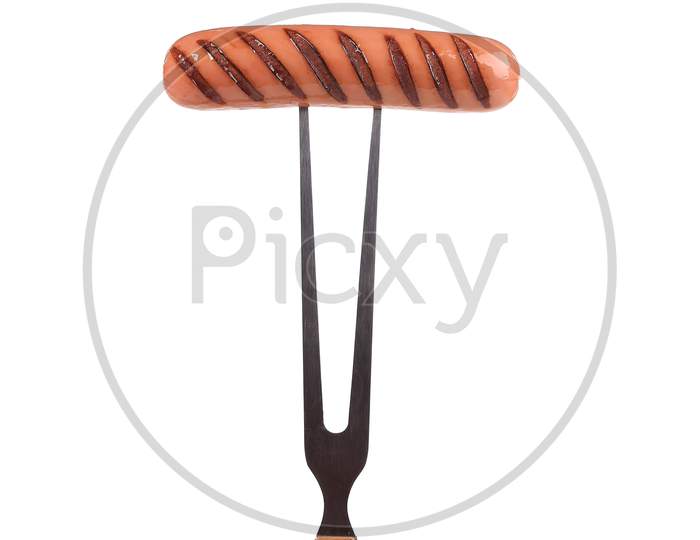 Grilled Sausage On A Fork. Isolated On A White Background.