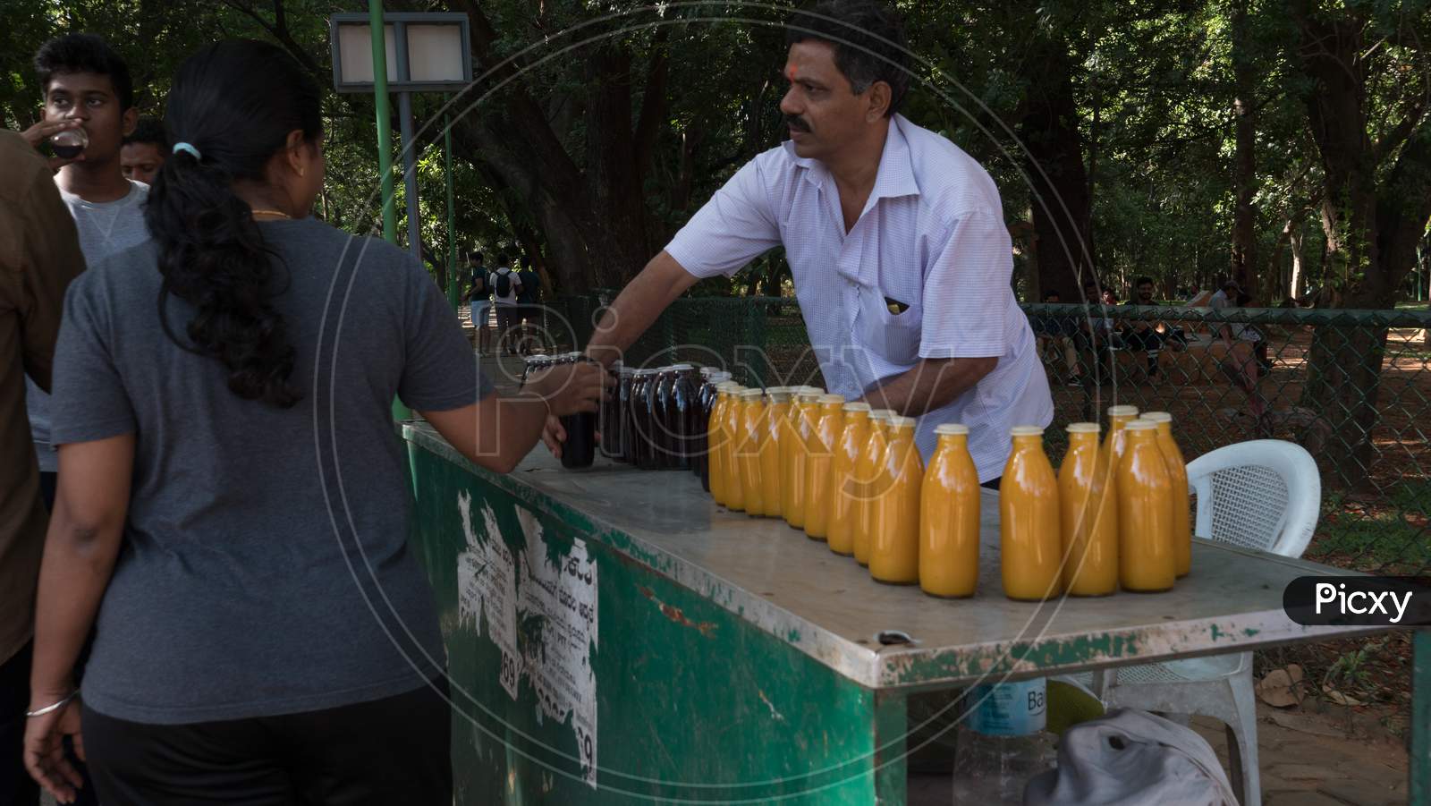 Bengaluru, Karnataka, India - 08 November 2019: People buying juice from the old and famous juice stall inside Cubbon park during their morning walk.