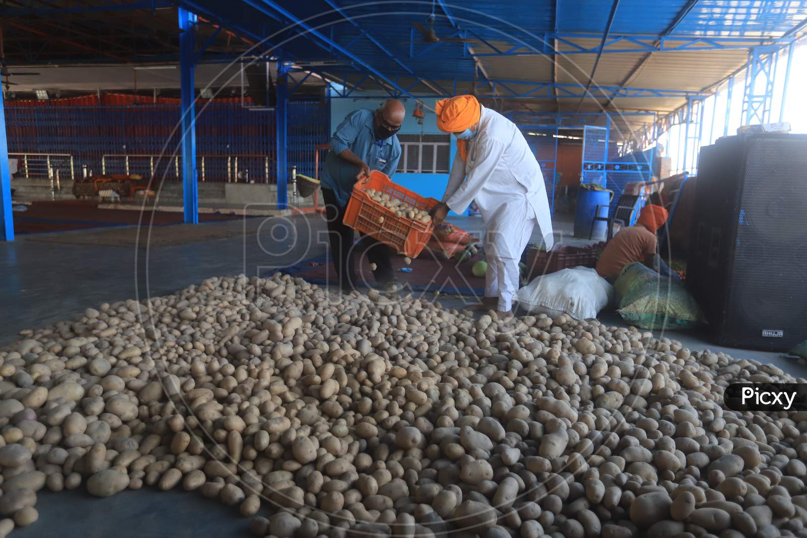 Social worker carry potatoes for food preparation of langar during a 21-day nationwide lockdown to limit the spreading of coronavirus disease (COVID-19), Prayagraj, April 3, 2020.