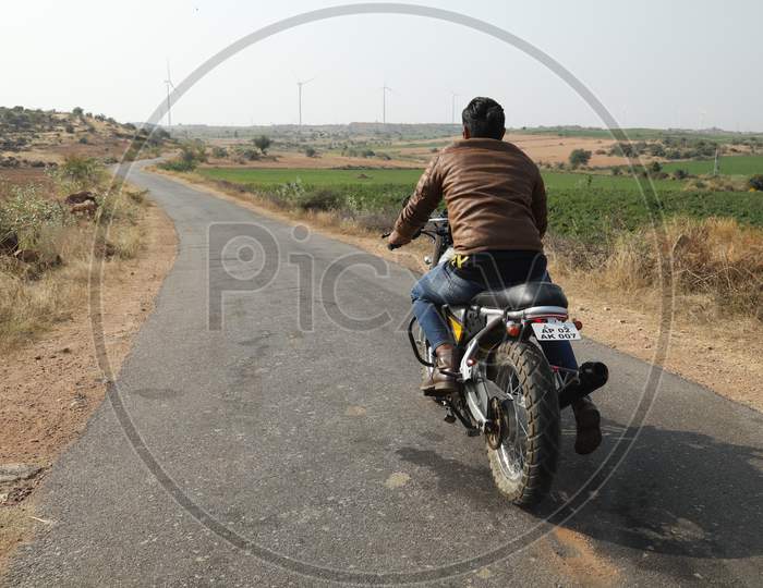 A Man Riding A Bike on Indian Rural Village Roads