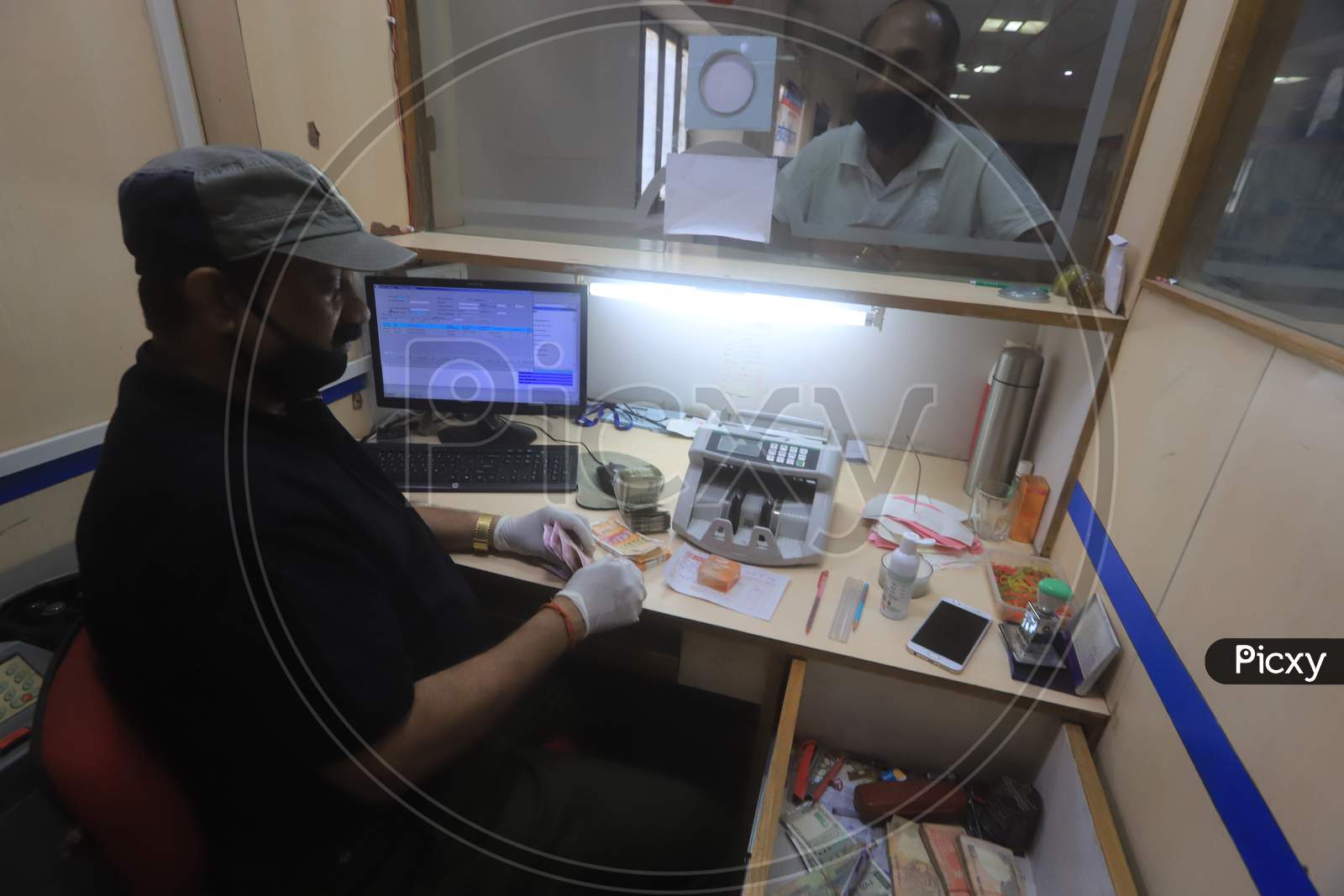 A bank employee working inside a bank during a 21-day nationwide lockdown to limit the spreading of coronavirus disease (COVID-19), Prayagraj, April 3, 2020.