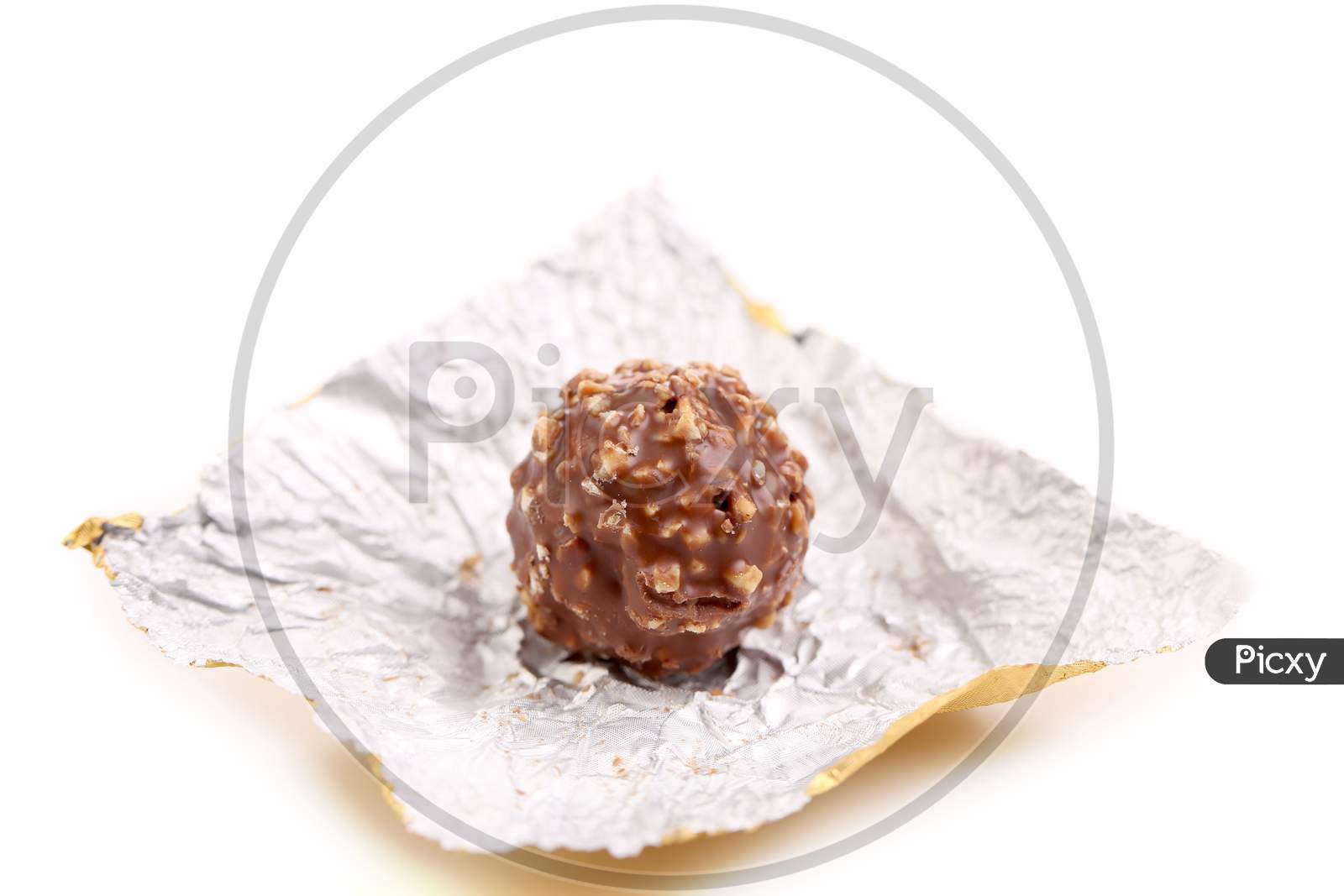 Chocolate On A Foil. Isolated On A White Background.