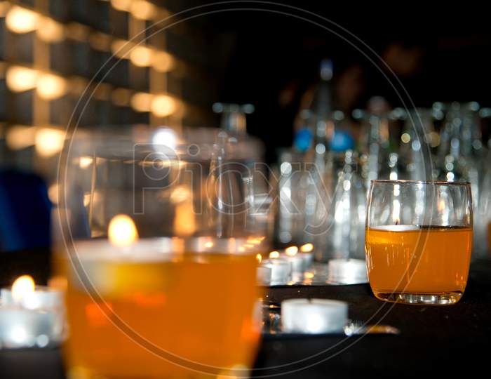 Alcohol Glasses At a Bar Counter Background