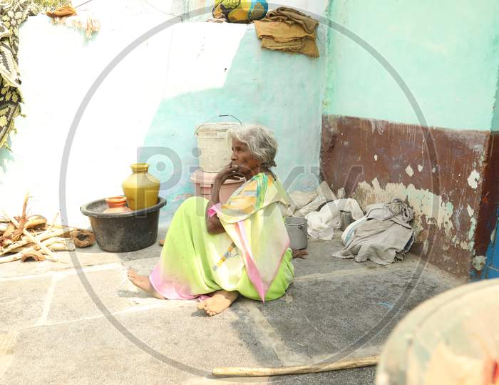 An Elderly Woman Sitting In an  Rural Village House
