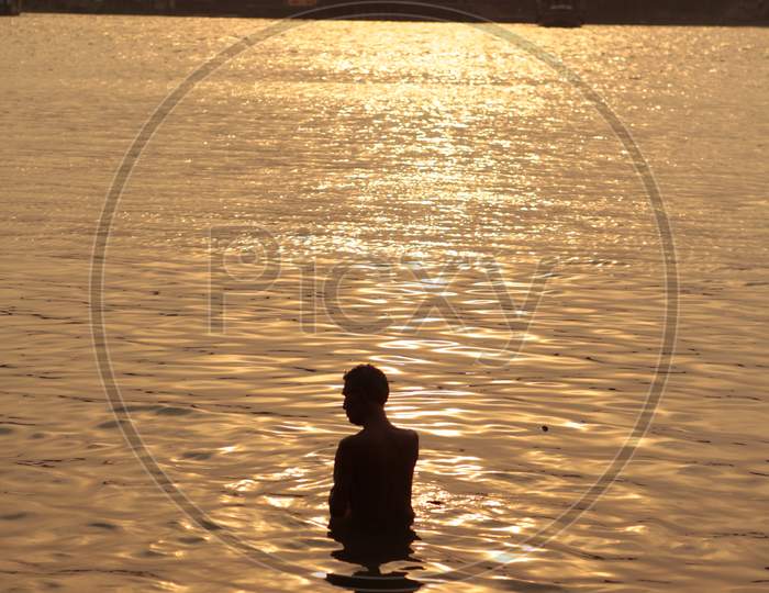 Silhouette Of a man Bathing in A Lake