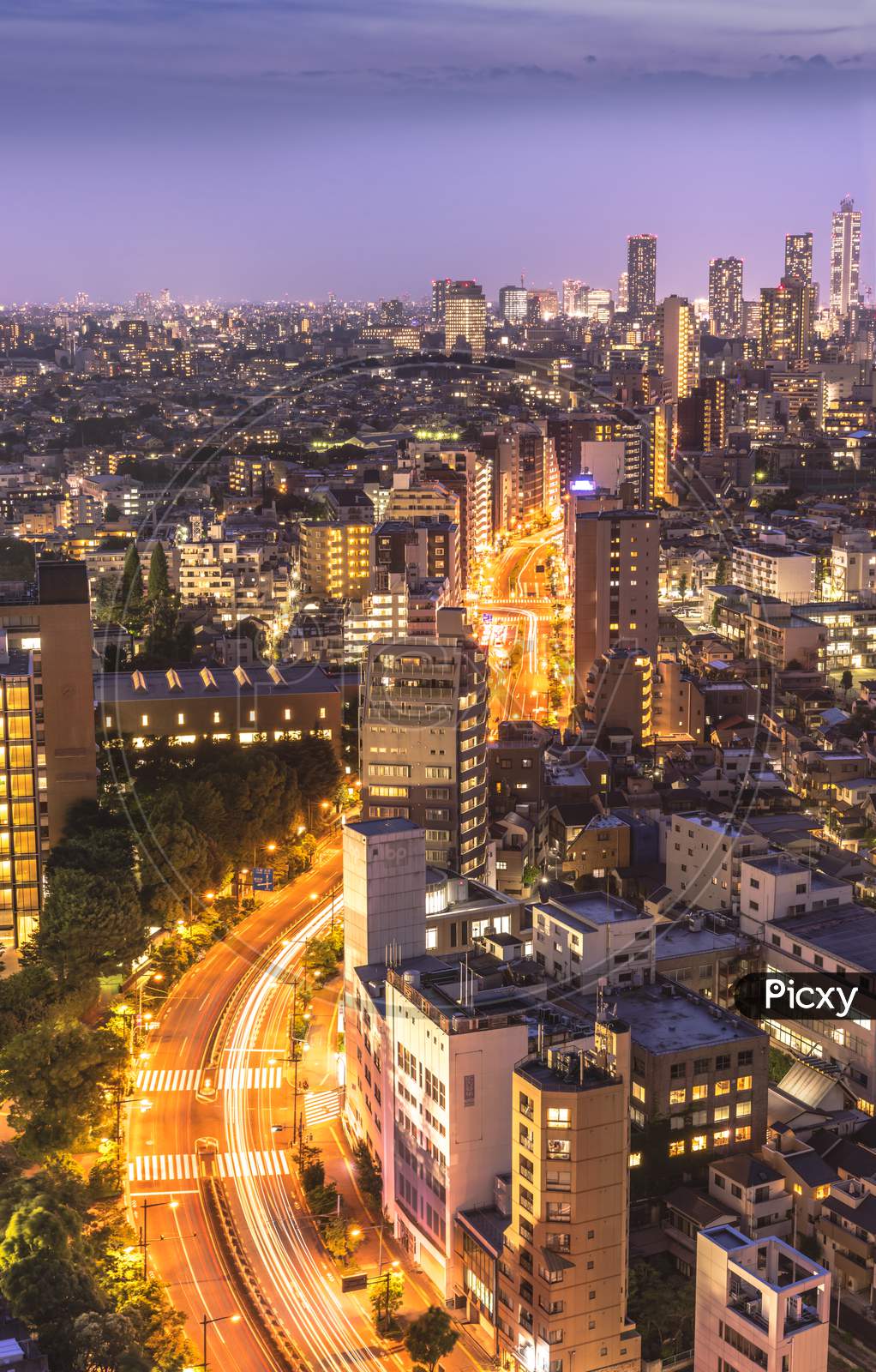 Aerial View Of Korakuen Illuminated Streets In The Night Of Tokyo With Ikebukuro Skyscrapers In Background.