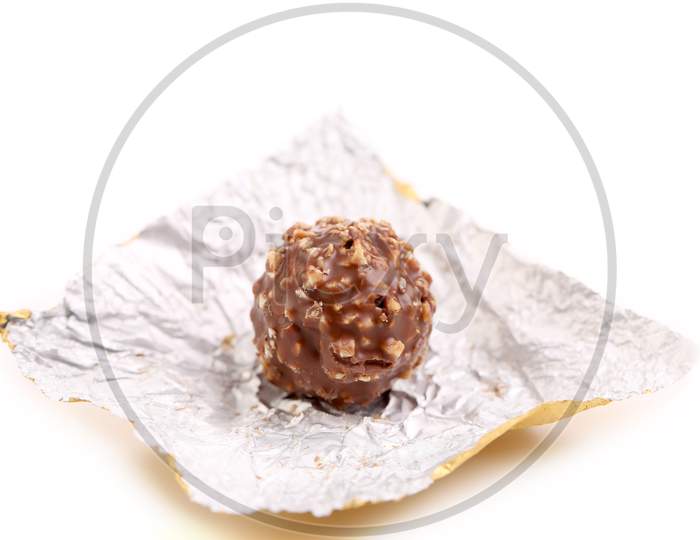 Chocolate On A Foil. Isolated On A White Background.