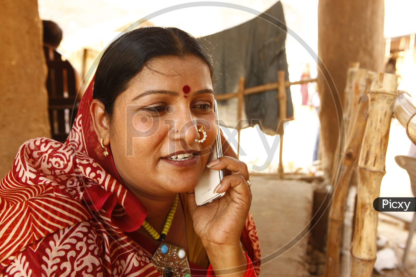 Rural Village Woman Speaking In Mobile Phone