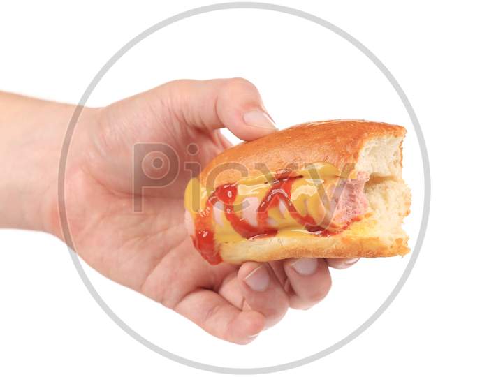 Hotdog With Ketchup In Hand. Isolated On A White Background.