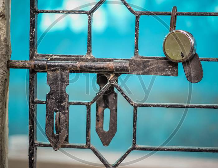 Iron Rod Gate With Lock And Key On Blue Background