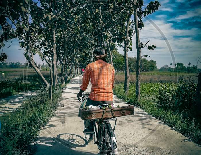 Rural diaries, a man riding bicycle
