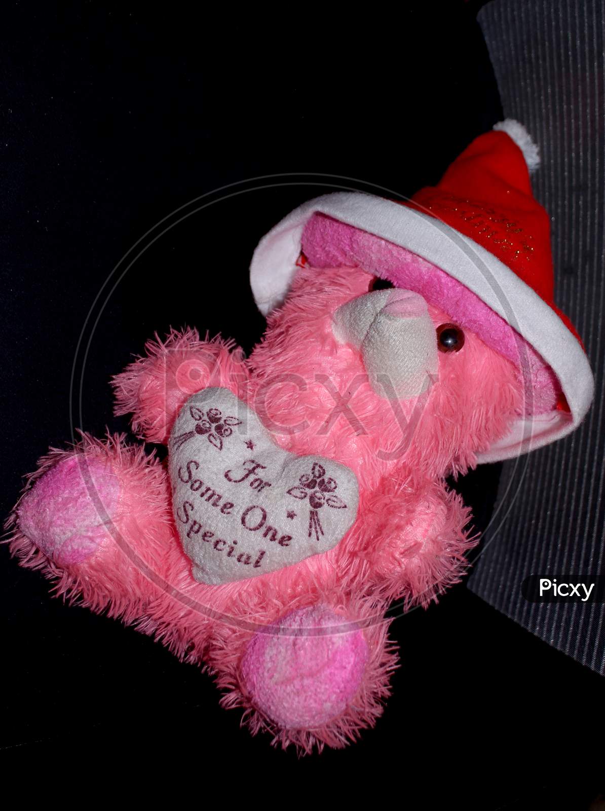 Pink Doll Or Toy On Black Background