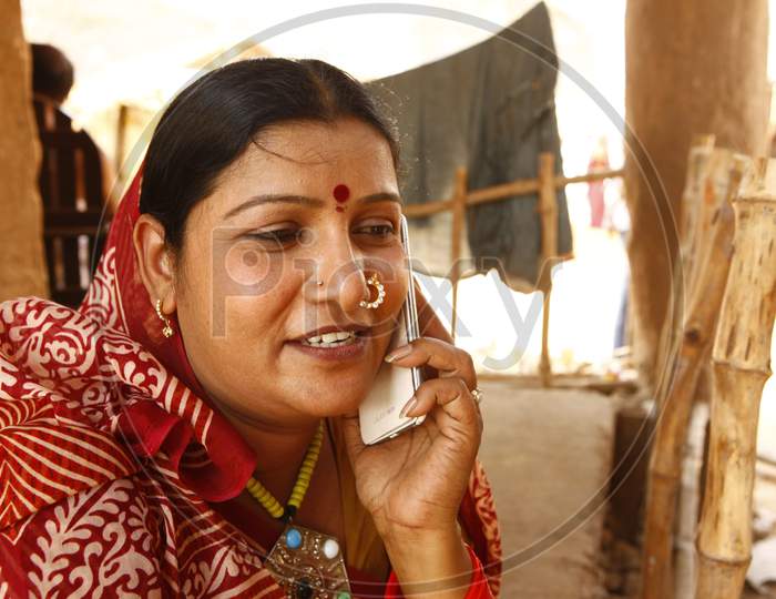 Rural Village Woman Speaking In Mobile Phone
