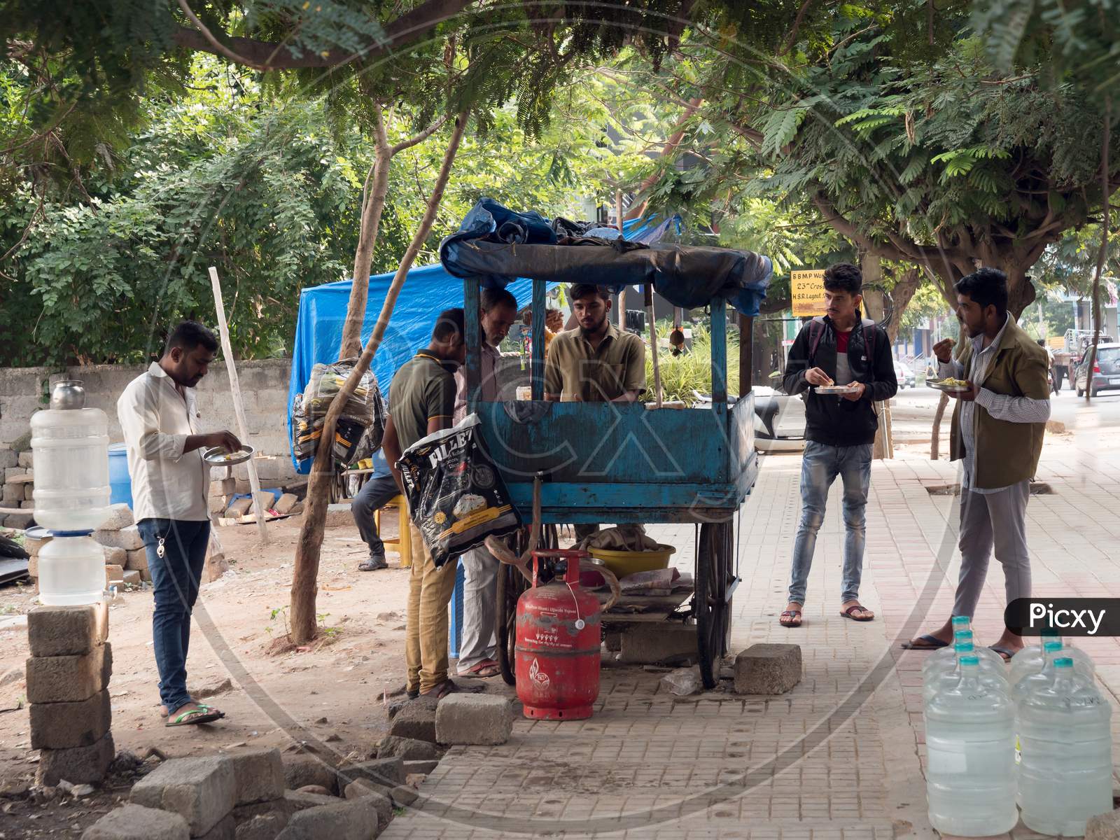 Bengaluru, Karnataka / India - November 19 2019: People eating at a road side makeshift eatery during day time