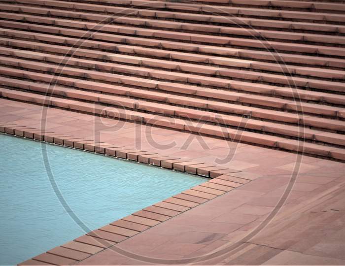 Landmark and Buildings Awesome view of red stone stairs approaching crystal clear blue water pool at Lotus Temple, Delhi, India