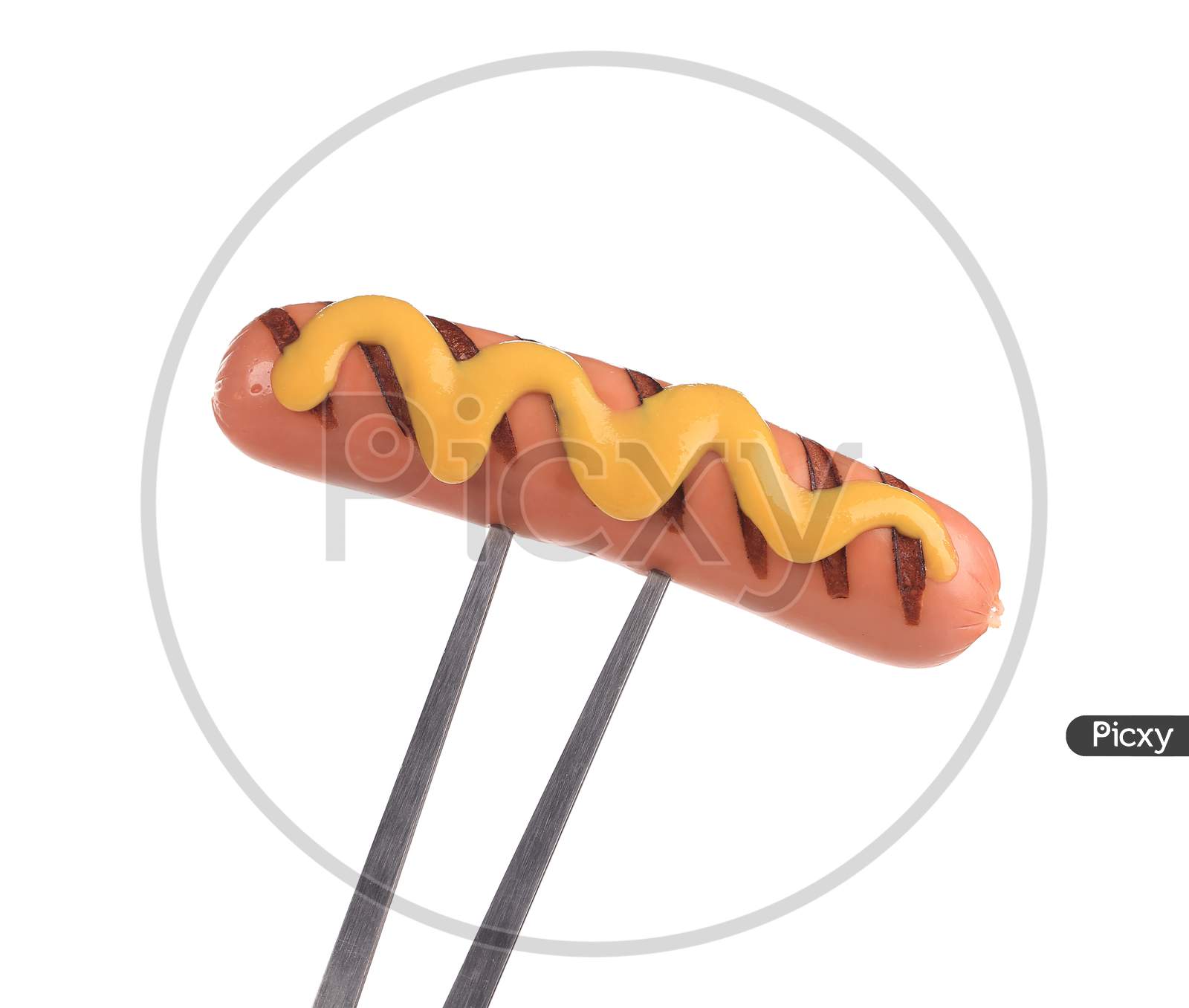 Grilled Sausage On A Fork. Isolated On A White Background.