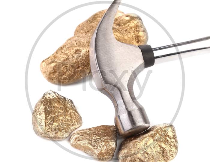 Closeup Of Metal Hammer With Gold Nuggets. Isolated On A White Background.