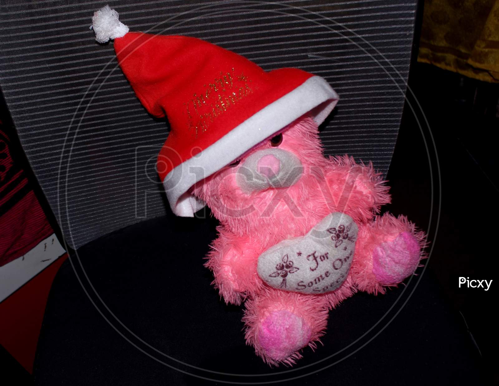 Pink Doll Or Toy On Black Background