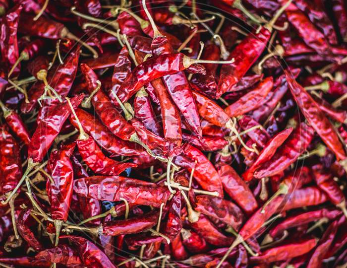 Dried Red Chilli Peppers.Top View Close Up Shot Of Spicy Red Chilli On Red Chilli Background For Cooking.Food Concept. Top View. Street Market View.