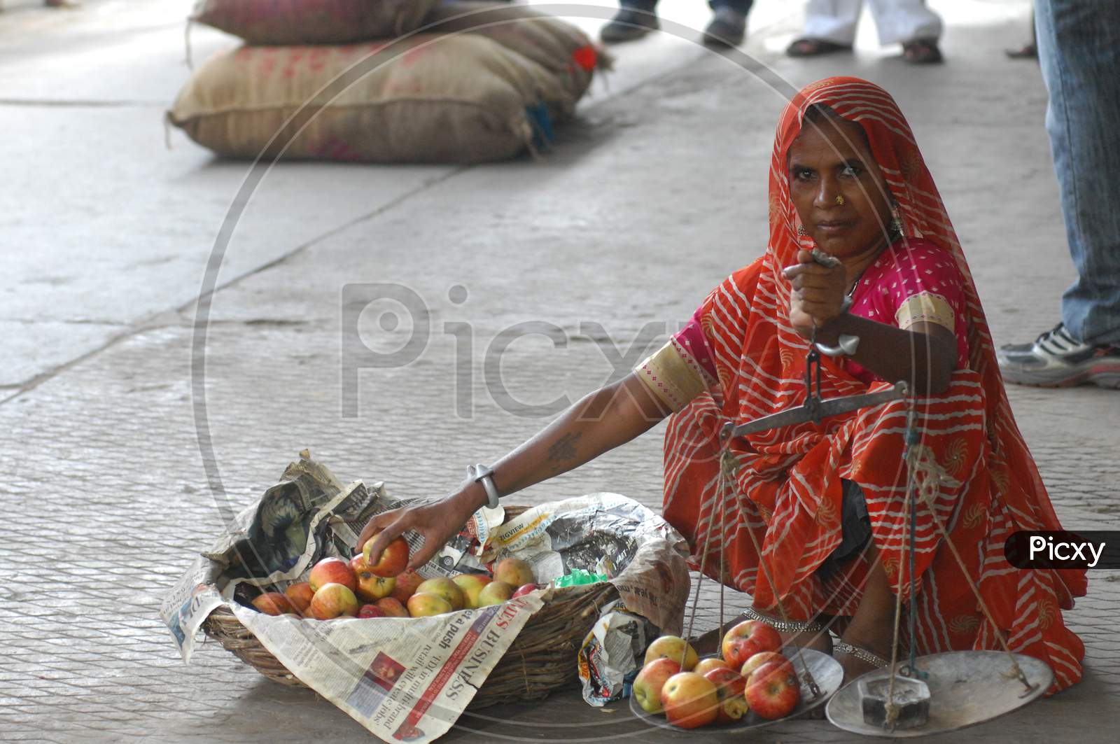 A Woman Vendor Selling Apples