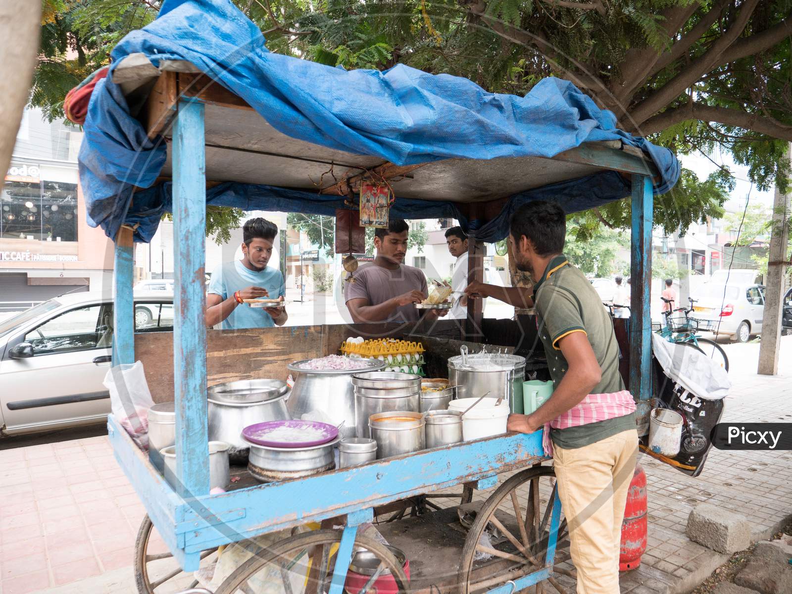 Bengaluru, Karnataka / India - November 19 2019: People eating at a road side makeshift eatery during day time