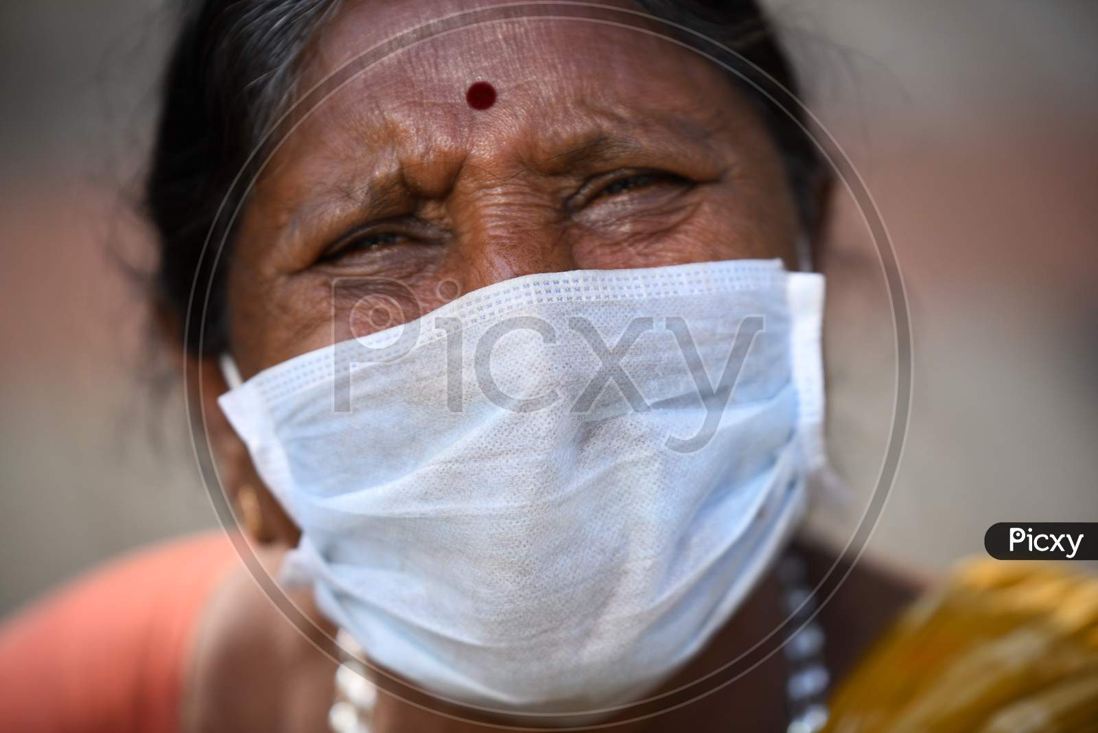 Roadside Woman vendor Wearing Mask Safety From Corona Virus or COVID 19 Virus Spread