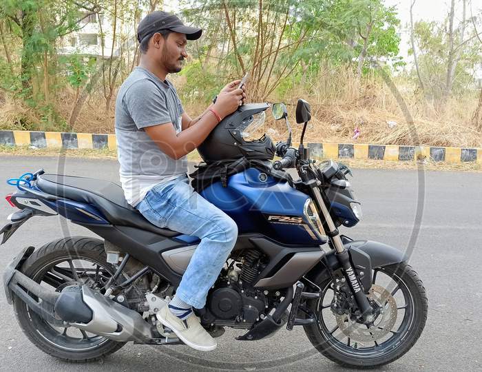 Indian College Student Using Mobile While Driving