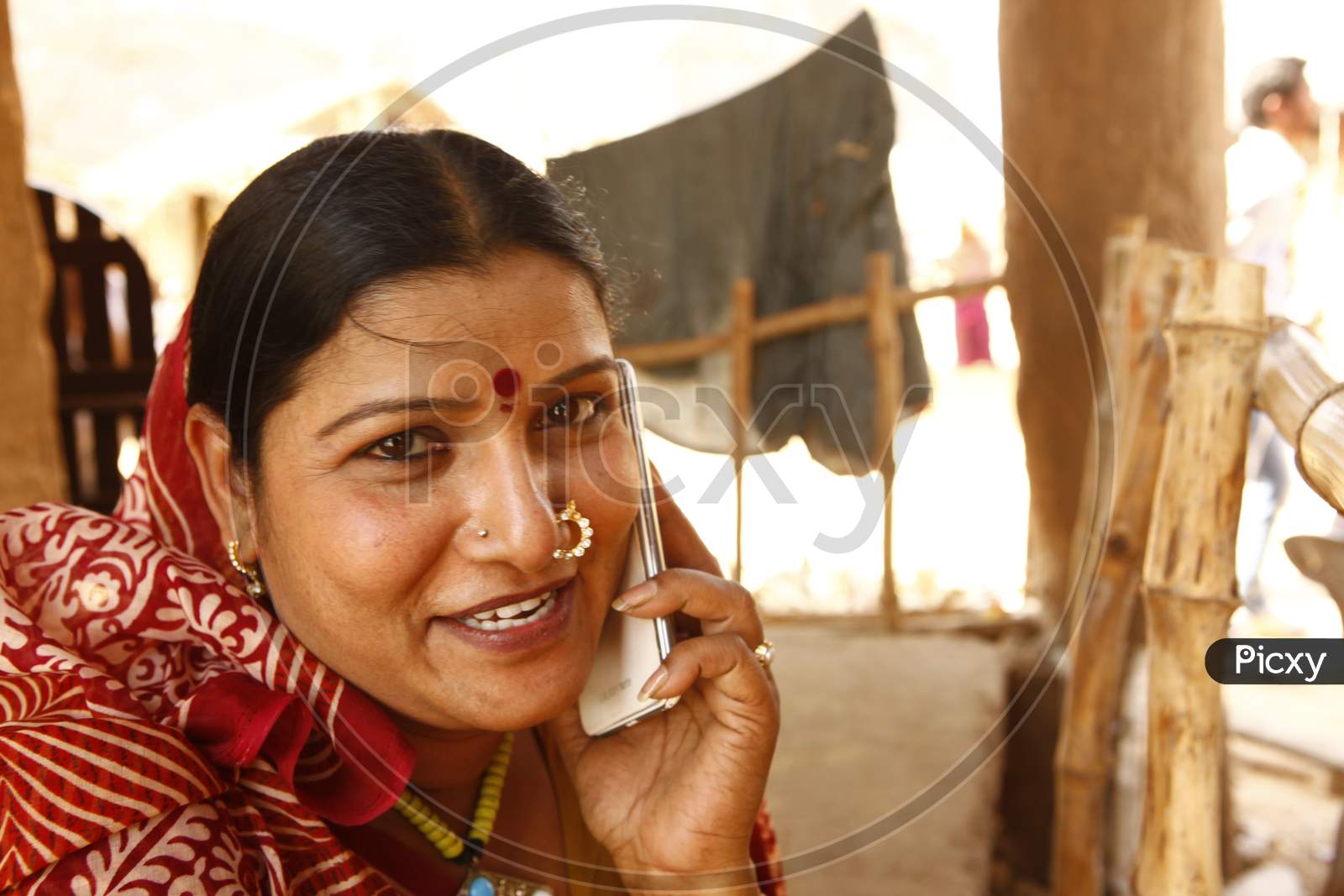Rural Village Woman  Speaking In Mobile Phone