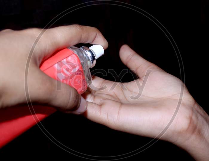 Close Up A Hand Is Using Hand Sanitizer From Bottle For Protective From Germs On The Hands, Covid-19 Protection, Selective Focus With Blur.
