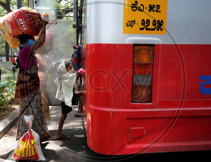 The child of migrant workers climbs into a bus prior to being repatriated to his village by the government during a nationwide lockdown to prevent the spread of coronavirus (COVID-19) in Bangalore, India, April 30, 2020.