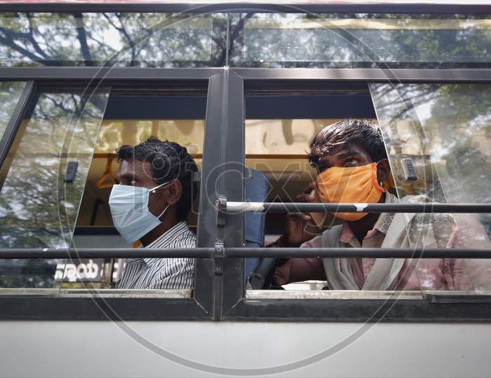 Migrant workers look out of a bus window prior to being repatriated to their villages by the government during a nationwide lockdown to prevent the spread of coronavirus (COVID-19) in Bangalore, India, April 30, 2020.