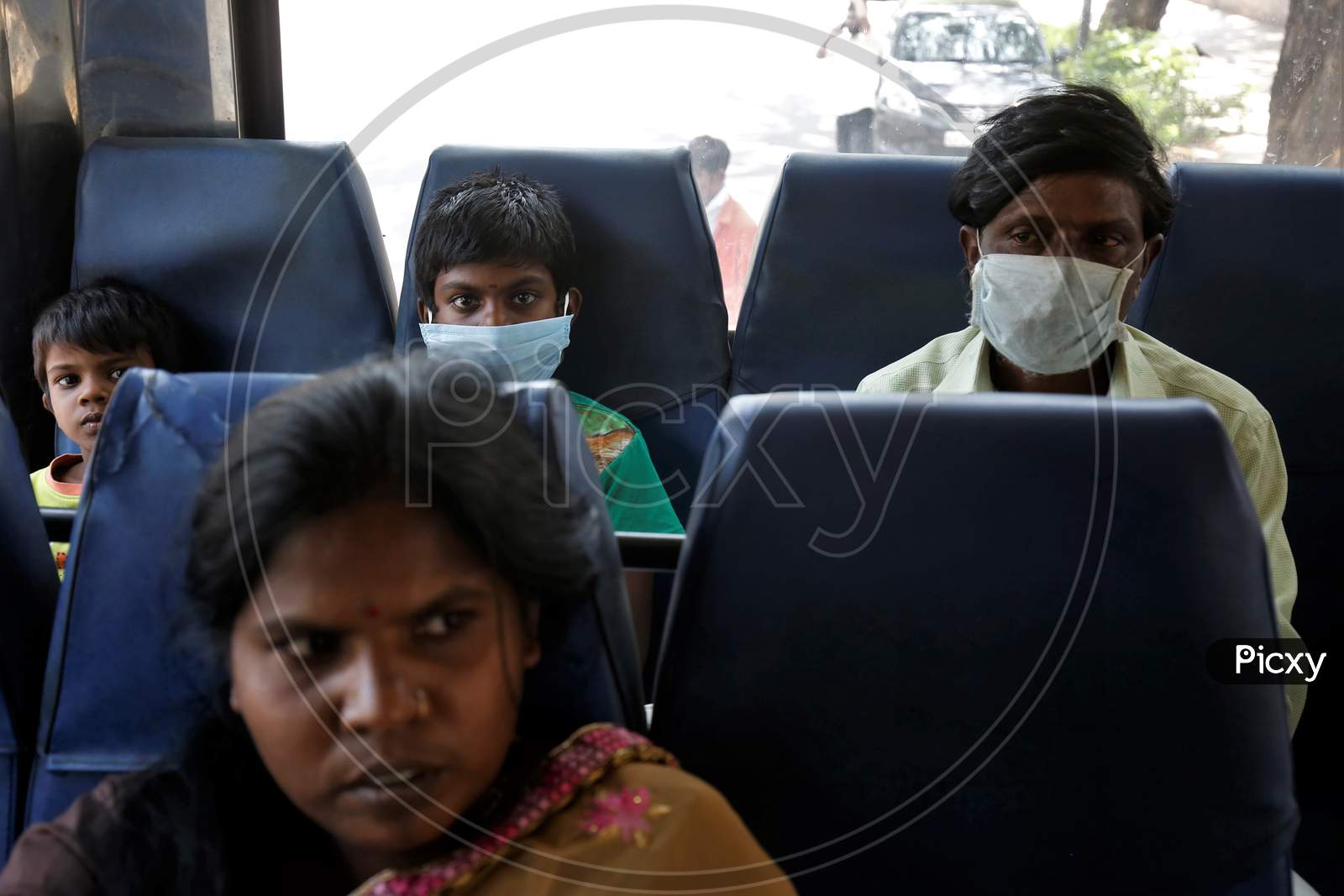 Migrant workers and their children sit in a bus before being repatriated to their villages by the government during a nationwide lockdown to prevent the spread of coronavirus (COVID-19) in Bangalore, India, April 30, 2020.