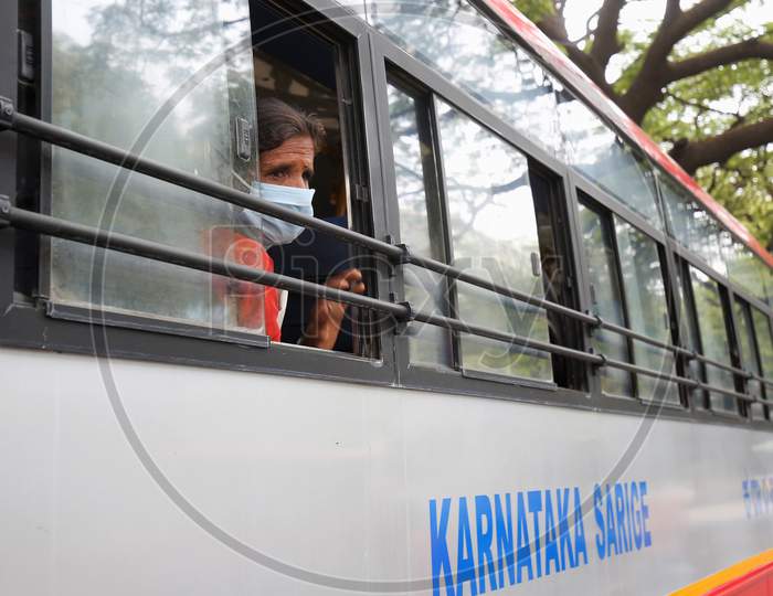 A migrant worker looks out of a bus window prior to being repatriated to her village by the government during a nationwide lockdown to prevent the spread of coronavirus (COVID-19) in Bangalore, India, April 30, 2020.