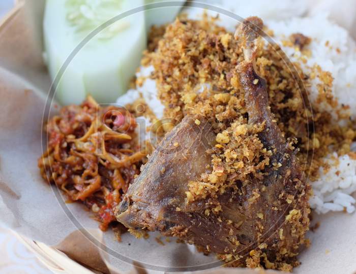 Crispy fried duck tasty and spicy "nasi bebek" served with Indonesian sambal