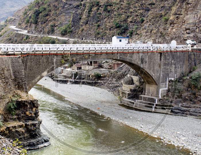 River Channel  Flowing In a Valley With Bridge